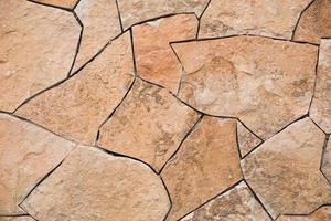 Masonry walls of natural sand color. Stone texture close-up, construction and mining background. photo