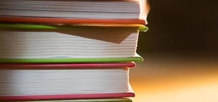 Close-up of a stack of books. The concept of home reading of paper books, school education and Institute, back to school. Space for text, background. photo