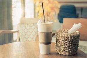 Morning sunlight through windows, shines on the coffee cup on the table in the cafe. photo