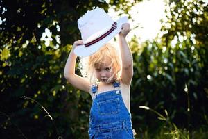Little blonde girl playing on countryside photo