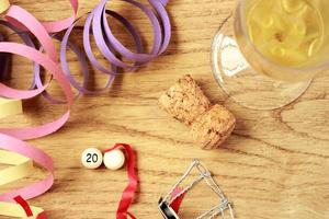 Party Decorations New Year's Eve with champagne on a parquet floor, with a white ball without a number, to put the year you want. Horizontal image. photo