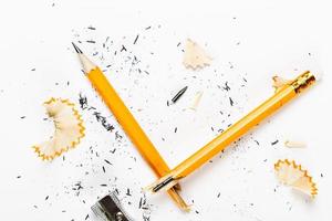 Pencil, metal sharpener and pencil shavings on white background. Horizontal image. photo