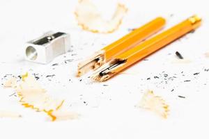 Pencil, metal sharpener and pencil shavings on white background. Horizontal image. photo