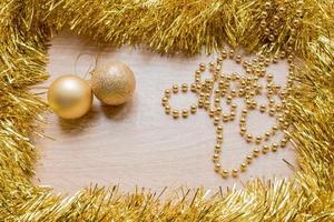 Christmas New Year holiday background. Golden tinsel and balls photo