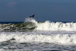 December 21, 2018 Israel. Surfing on high waves in the Mediterranean. photo