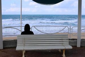 Bench for rest in the city park on the seashore. photo