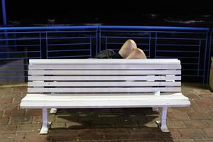 Bench for rest in the city park on the seashore. photo