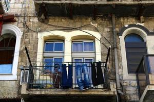 Outside the window, laundry is being dried on a rope on the facade of the building. photo