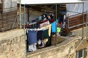Outside the window, laundry is being dried on a rope on the facade of the building. photo
