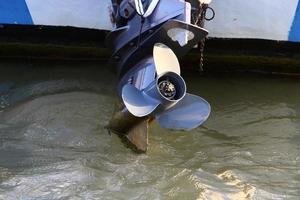 Motor and propeller of a motorboat. photo