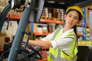 Female worker driving a forklift moving goods in the warehouse Practicing forklift operation photo