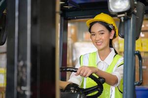 Female worker driving a forklift moving goods in the warehouse Practicing forklift operation photo