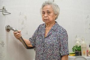 Asian senior or elderly old lady woman patient use slope walkway handle security with help support assistant photo