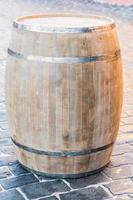 wooden barrel on pavement outdoors photo