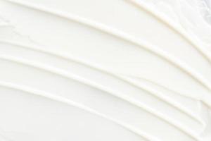 White cosmetic cream texture. Beauty balm, lotion, skincare background. Strokes of cream photo