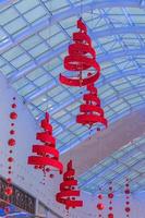 christmas decoration of shapping mall. Garlands and trees hanging on ceiling photo