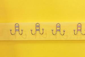 Metal Hanger Hook on yellow wooden desk photo