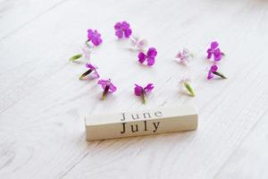 first day of July, colorful background with calendar, flowers photo