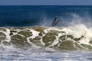 December 21, 2018 Israel. Surfing on high waves in the Mediterranean. photo