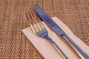 Served fork and knife on table. photo