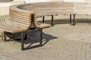 wooden bench on pavement photo