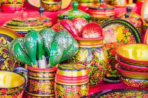 Khokhloma utensils. Wooden spoons and bowls in in Russian folk style photo