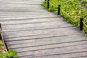 Closeup of wooden bridge in a park during summer photo