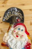 Decorative gnome with sign Welcome. photo
