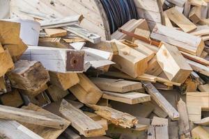 pile of wooden logs and desks outdoors photo