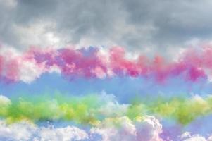Colorful smoke in blue sky with clouds photo