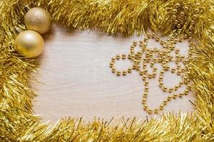 Christmas New Year holiday background. Golden tinsel and two sparkle balls. Copy space photo