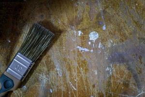 paint brush on dirty woodent table. wooden ackground photo