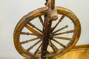 closeup of antique wooden spinning wheel photo