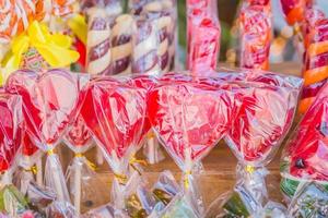 closeup of colorful lollipops n heart shape in a shop photo
