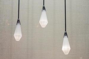 three hanging electric lamps on canvas background photo