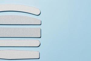 Set of polishing files for nails. Tools for manicure on a blue background with copy space photo