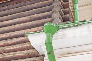 Corner of the house with gutter in winter photo