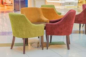 multicolored velvet armchairs around table in lounge zone