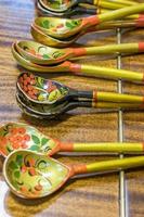 Khokhloma spoons on wooden table photo