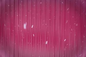 metal fence background and falling snow photo