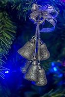 Christmas bells hanging on the tree photo