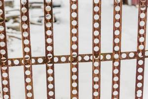 perforated fence on snow background. photo