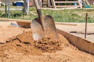 construction worker with a shovel, foundation preparation on construction site photo