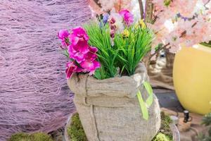 artificial flowers in canvas bag outdoors, street decorations close up photo