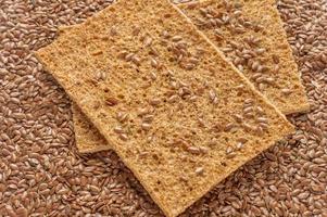 flax seeds and two slices of rye bread background photo