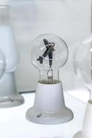 lightbulb on glass shelf photo