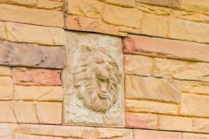 Lion sculpture vintage decoration on the wall. photo