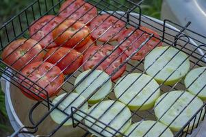 Charcoal grill with vegetables. zucchini and tomatoes. photo
