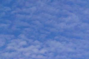 blye sky with white fluffy clouds background photo