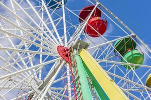 colorful ferris wheel against blue sky with clouds photo